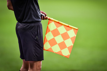Assistant referee moving along the sideline during a soccer match