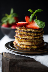 Banana pancakes with strawberries and mint