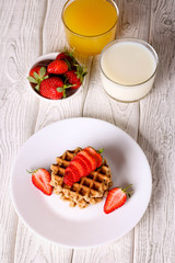 Waffels with strawberry on a white plate