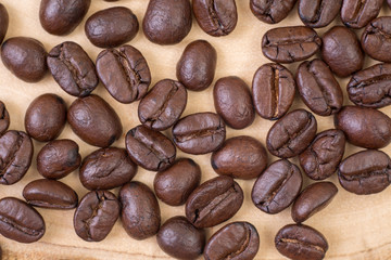 Top view of close up roasted coffee beans on wood texture background