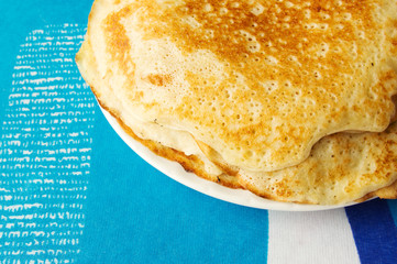 Fresh homemade pile of pancakes on a colorful background