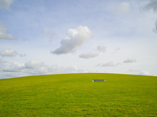 A water trough in a field with a cloudy sky on the South Downs National Park Sussex UK