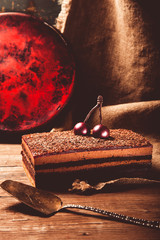 Homemade cherry cake with chocolate decor on a rustic style background. Selective focus. Toned