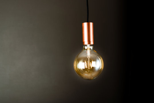 Lightbulb hanging in a dark room