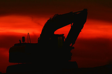 EXCAVATOR - construction machine at dusk on construction site © Wojciech Wrzesień