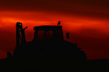 MULTIFUNCTION MACHINE - construction machine at dusk on construction site © Wojciech Wrzesień