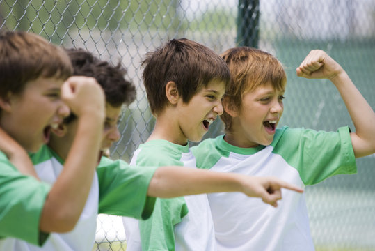 Young teammates cheering from sidelines