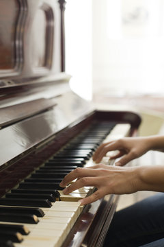 Woman's hands playing piano