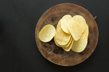Pile of potato chips on cutting board