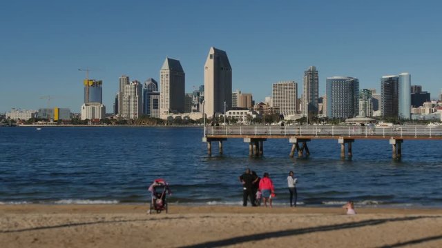 SAN DIEGO, CA - Circa February, 2017 - People on a beach on Coronado Island view the San Diego skyline on a sunny day.	
