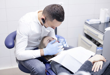 Beautiful girl with braces on the teeth, at a reception at the dentist