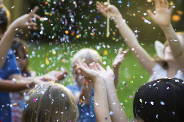 Children showered in falling confetti
