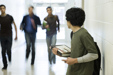 Teenage boy running from bullies