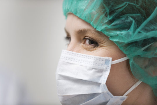 Close-up of nurse with surgical mask and surgical cap at hospital