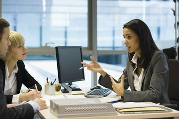 Female executive talking to colleagues