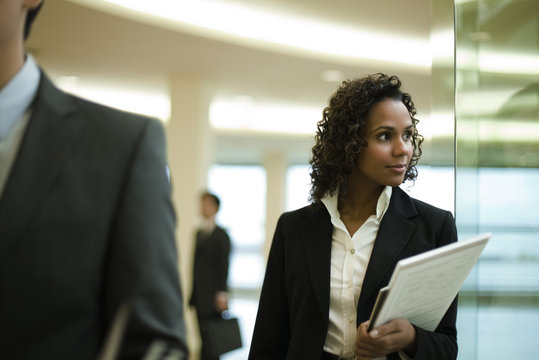 Businesswoman looking out window, portrait