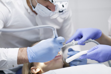 Dental cure. Molar treatment. Young female patient visiting dentist office. 