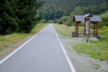 straight asphalt bicycle path in a mountain valley