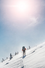 Ski touring in extreme winter conditions at snow storm and blizzard