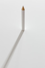 White pencil on white paper with diffused  shadow