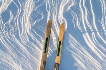 Pair of wooden skis on the snow