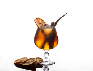 Fresh cocktail with coca-cola, ice, cinnamon and lemon on white background. Isolated coctail