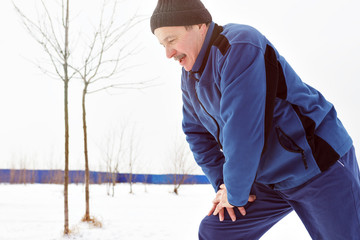 Man warming up before running in the winter on snow