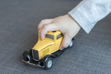 Child playing with toy car