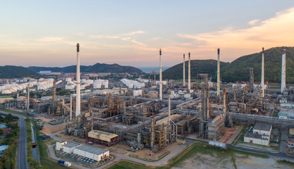 Aerial view Oil refinery with a background of mountains and sky.The factory is located in the middle of nature and no emissions. The area around the air pure.