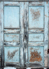 Vintage old blue wooden door with cracked paint