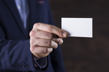 Businessman holding a blank business card