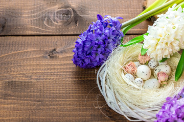 Beautiful Easter eggs with flowers hyacinths on the wooden background