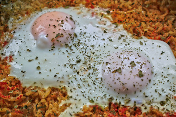Closeup of two fried eggs on rice
