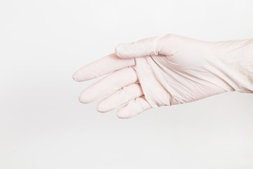 Female hand in white natural rubber latex glove isolated on white background. Horizontal color...