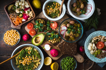Different salad and snack on the wooden table top view