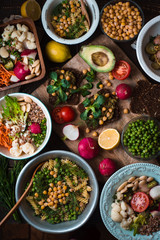 Different salad and appetizer on the wooden table top view