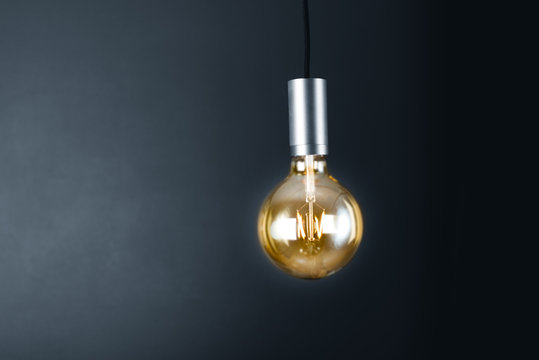 Lightbulb hanging in a dark room
