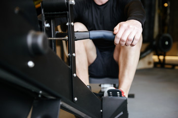 Cropped image of Muscular man using rowing machine © Drobot Dean