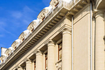 House Roof Covered In Snow And Dangerous Icicles