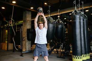 Young Athletic man doing exercise with weight