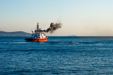 Coast guard vessel emitting black smoke cruising in Istanbul Bosphorus