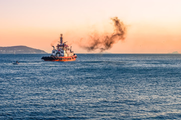 Obraz premium Coast guard vessel emitting black smoke cruising in Istanbul Bosphorus