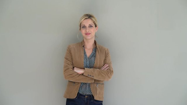 Middle-aged woman standing on grey background, isolated