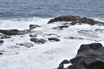 Waves against a cliff making a lot of white foam