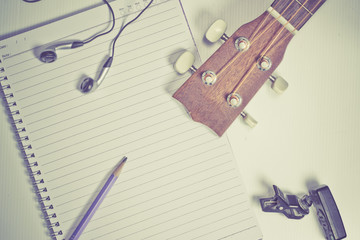 concept song composer:Notebook and pencil ,Ukulele ,style vintage