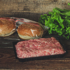 Set for burgers (minced meat, buns, lettuce leaves and so on)
