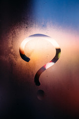 Autumn rain, the inscription on the sweaty glass - question mark
