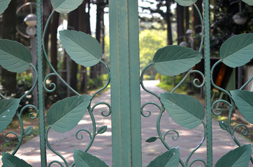 Green leaf shape grill.  Green iron gate details.
