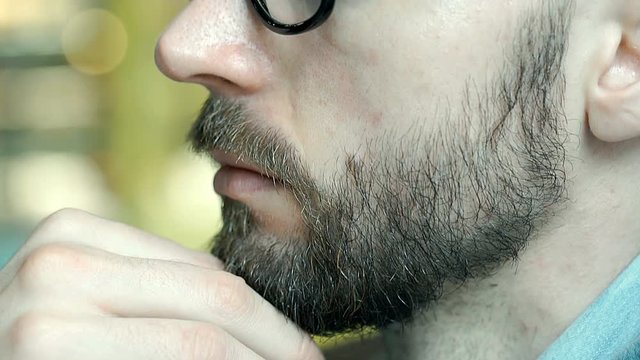 View of handsome man's face profile, close up, steadycam shot
