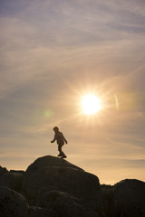 Girls playing at sunset on top of the mountain